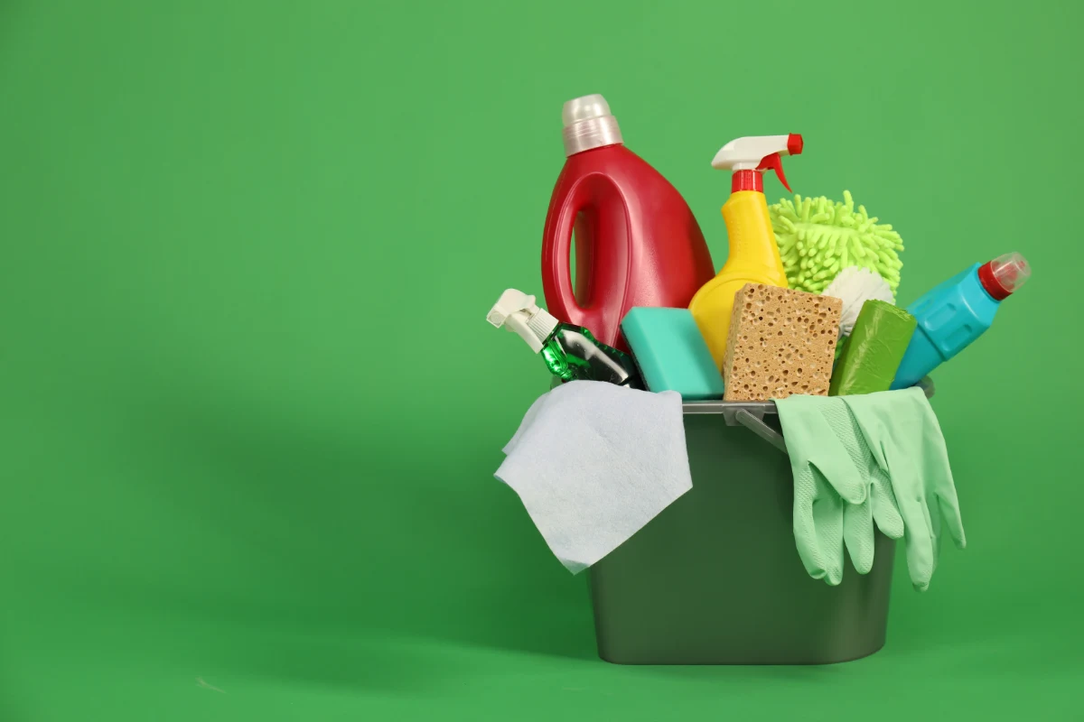 different-cleaning-products-bucket-green-background-space-text